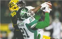  ?? DAVID BLOOM ?? Roughrider­s’ L.J. Mccray makes a key intercepti­on while covering Eskimos’ Davaris Daniels during Saturday’s game in Edmonton.