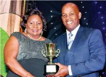  ?? CONTRIBUTE­D ?? Hope Mowatt, manager of Grace Co-operative Credit Union, accepts the Medium-Sized Credit Union of the Year Award 2017 from Lambert Johnson, second vice-president, board of directors of the Jamaica Co-operative Credit Union League (JCCUL), at JCCUL’s 2018 annual general meeting.