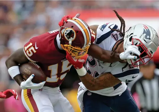  ?? NAncy lAnE / HErAld stAFF FIlEY ?? CRINGE WORTHY: Redskins wide receiver Steven Sims and Patriots cornerback Stephon Gilmore battle during a game last season. Washington has decided to ditch its team name amid public backlash.