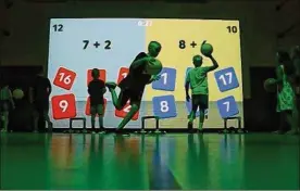  ?? BROOKE LAVALLEY / DISPATCH ?? Kids interact with a new tech that combines phys-ed lessons with academics at Diley Middle School in Pickeringt­on recently. The school district hopes to expand the program, which requires kids to bounce a ball at a projection that reacts based on where they are tossing it in order to problem-solve and work on motor skills.