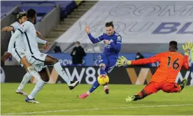  ?? Photograph: Tom Jenkins/NMC Pool/The Guardian ?? James Maddison fires past Édouard Mendy to set the victory over Chelsea that leaves Leicester top of the Premier League.