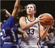  ?? Jessica Hill / Associated Press ?? UConn’s Caroline Ducharme drives to the basket as Seton Hall’s Lauren Park-Lane, left, defends in the first half on Jan. 21 in Storrs.