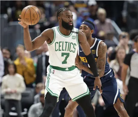  ?? Ap ?? POST TIME: Jaylen Brown looks to pass the ball as Denver’s Will Barton defends in the first half of Sunday night’s 124-104 win over the Nuggets.