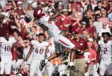  ?? Associated Press ?? Tough catch: Arkansas wide receiver Jordan Jones (10) attempts to catch a pass against South Carolina. Jones, a redshirt freshman from Smackover, had three receptions for 37 yards and a touchdown in the Razorbacks' 48-22 loss Saturday in Columbia, S.C.