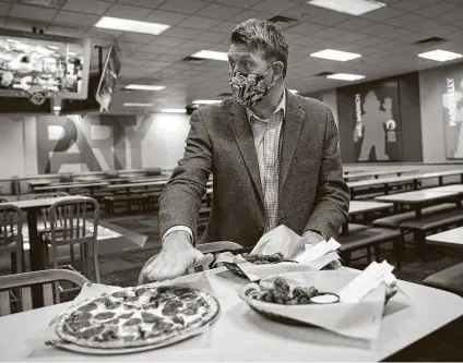  ?? Annie Mulligan / Contributo­r ?? CEO David McKillips, who joined Chuck E. Cheese in January, shows some of the menu items at one of its restaurant in Sugar Land.