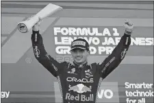  ?? TORU HANAI/AP PHOTO ?? Red Bull driver Max Verstappen of the Netherland­s celebrates on the podium after winning the Japanese Formula One Grand Prix on Sunday at the Suzuka Circuit, Suzuka, central Japan.