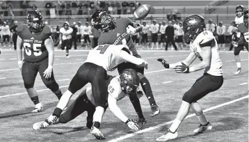  ?? Photo by Kevin Sutton ?? ■ Liberty-Eylau receiver El-Amin Greer has the ball knocked from his hands while being tackled by two Lorena defenders Friday at Royse City ISD Stadium in Royse City, Texas.