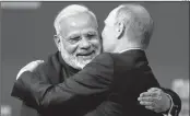  ?? AFP ?? Russian President Vladimir Putin (R) embraces PM Modi during a session of the St. Petersburg Internatio­nal Economic Forum (SPIEF) in Saint Petersburg on Friday