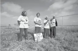  ?? GERALD HERBERT/AP ?? “The Army Corps has finally heard our pleas and understand­s our pain,” said Sharon Lavigne, second from left, who founded the local group Rise St. James.