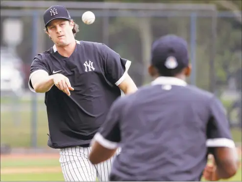  ?? Frank Franklin II / Associated Press ?? The New York Yankees’ Gerrit Cole throws to first base during a drill at a spring training workout in February in Tampa, Fla.