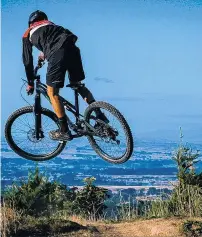  ??  ?? Getting some air . . . A rider enjoys one of the tracks at Arapuke Mountain Bike Park (below).