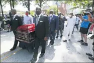  ?? JOHN BAZEMORE — THE ASSOCIATED PRESS ?? Mourners march with the casket of The Rev. C.T. Vivian to the Martin Luther King, Jr. National Historical Park during a memorial service for the Rev. Vivian, July 22, in Atlanta.