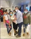  ?? CONTRIBUTE­D ?? From left, Ana Guillen holding her daughter Daniela, Jorge Escobar de Guillen, Santos Guillen Hernandez and Karla Elizabeth Guillen Escobar pose for a photo at the Mccarran Internatio­nal Airport luggage carousel after Jorge and Karla’s arrival from El Salvador.