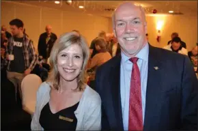  ?? RON SEYMOUR/The Daily Courier ?? Shelley Cook and B.C. Premier John Horgan pose for a photo Sunday at the West Kelowna Holiday Inn.