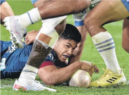  ?? PHOTO: GREGOR RICHARDSON ?? Slipping under . . . Highlander­s No 15 Josh Ioane dots down for a try in the first half of their match against the Blues at Forsyth Barr Stadium on Friday evening.