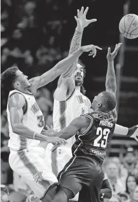  ?? [PHOTO BY SARAH PHIPPS, THE OKLAHOMAN] ?? Oklahoma City’s Josh Huestis, left, and Steven Adams, center, defend against Melbourne’s Casey Prather in the fourth quarter of a preseason game on Sunday at Chesapeake Energy Arena.