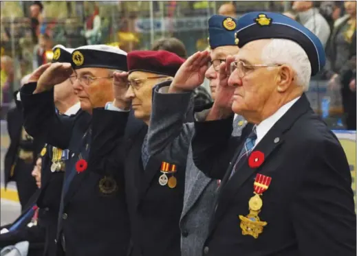  ?? BARB AGUIAR/Westside Weekly ?? Veterans salute during Remembranc­e Day ceremonies inside Royal LePage Place last year.