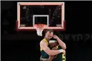  ?? Photograph: Aris Messinis/AFP/Getty Images ?? ‘No words needed to be said to either of us’: Mills and Joe Ingles embrace in the moments after Australia won the men’s bronze medal match against Slovenia.