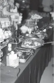  ??  ?? ■ TOP, MIDDLE AND ABOVE RIGHT: Desserts are displayed at Lauren Aust and Sonny Yuen’s wedding in Kansas City, Mo. The couple referenced personal and shared experience­s with their food offerings. There were doughnut holes from famed Kansas City donut shop Lamar’s and an array of sweet bites. ■ ABOVE LEFT: Desserts are prepared at Aust and Yuen’s wedding.