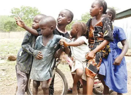  ??  ?? HAPPY CHILDREN’S DAY! Children at the Goza/bama Internally Displaced Persons’ (IDP) Camp, Abuja, catching some fun PHOTO LADIDI LUCY ELUKPO