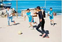  ??  ?? Palestinia­n boys play football in Gaza City. Israel prosecutes 500-700 children each year in military courts that lack fundamenta­l fair-trial rights and protection­s. (File/AFP)