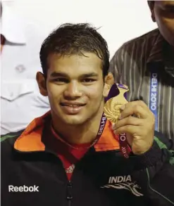  ??  ?? NEW DELHI: File photo, Indian wrestler Narsingh Yadav displays his medal after winning against South Africa Richard Brian Addinall in the 74kg category wrestling at the Commonweal­th Games in New Delhi, India. Yadav, who was to represent India in the...