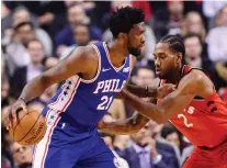  ?? THE CANADIAN PRESS/FRaNK GUNN ?? The Raptors’ Kawhi Leonard defends the 76ers’ Joel Embiid, who struggled in his team’s loss on Wednesday.