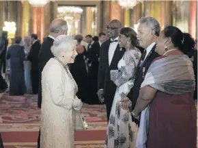  ??  ?? Queen Elizabeth II greets Enele Sopoaga, Prime Minister of Tuvalu in the Blue Drawing Room at The Queen’s Dinner during the Commonweal­th Heads of Government Meeting (CHOGM) at Buckingham Palace on April 19, 2018 in London, England.