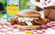  ?? BeccaWrigh­t ?? Fried chicken breast sandwich with coleslaw and pickles on a brioche bun at Mico's Hot Chicken