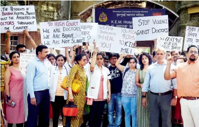 ?? PTI ?? Resident doctors along with senior doctors during a rally at the KEM hospital demanding security after an intern was assaulted by patient’s relatives, in Mumbai, on Wednesday. —
