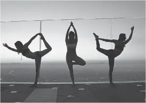  ?? SZUSZANIK HOVAKIMYAN ?? Yoga reaches new heights with a class at OUE Skyspace LA, a Los Angeles skyscraper observatio­n deck.