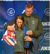  ??  ?? Kiwi chef de mission Rob Waddell drapes Sophie Pascoe in the New Zealand flag.