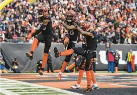  ?? JEFF DEAN/AP ?? Bengals running back Joe Mixon, center, celebrates a touchdown against the Ravens in the first half of Sunday’s game in Cincinnati.