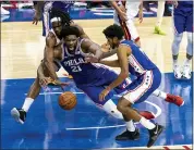  ?? CHRIS SZAGOLA - THE ASSOCIATED PRESS ?? The Philadelph­ia 76ers’ Joel Embiid, center, battles with the Miami Heat’s Precious Achiuwa, left, for a loose ball as Isaiah Joe, right, tries to help during overtime of Tuesday’s game in Philadelph­ia.