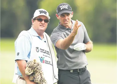  ?? Picture: Gallo Images ?? SINGLE-MINDED. Charl Schwartzel, pictured here with his caddie during a pratice round at Glendower Golf Club yesterday, is desperate to add the SA Open title to his CV.