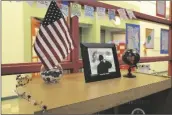  ?? ?? THE READING SPACE includes decoration­s such as this American flag, globe and photo of Private First Class Pedro Alvarez Delgado.