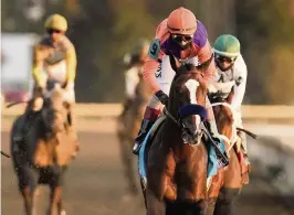  ?? MARK HUMPHREY AP ?? John Velazquez rides Authentic to a 2 length victory over Improbable in the Breeders’ Cup Classic at Keeneland Race Course in Lexington, Ky., on Saturday.