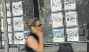  ?? GETTY IMAGES//AFP ?? Luxury apartments are advertised in a realtor’s window on the West Side of Manhattan on July 24, 2018.