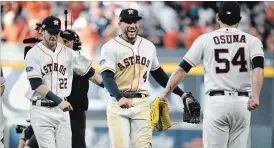  ?? ERIC CHRISTIAN SMITH THE ASSOCIATED PRESS ?? Astros’ Josh Reddick, George Springer and Roberto Osuna celebrate after the Astros’ win.