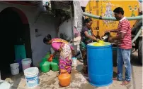  ?? — AP ?? Residents of Bengaluru’s Ambedkar Nagar, a low-income settlement in the shadows of global software companies in Whitefield neighbourh­ood, collect potable water from a private tanker on March 11, 2024.