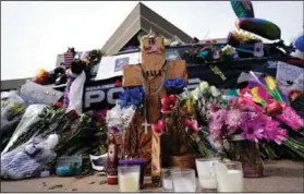  ?? (AP/David Zalubowski) ?? Tributes Thursday cover a police cruiser that was driven by slain officer Eric Talley in Boulder, Colo.