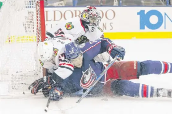  ?? | JAY LAPRETE/ AP ?? The Blue Jackets’ Josh Anderson and Blackhawks’ Trevor van Riemsdyk collide during the second period. Van Riemsdyk left the game and didn’t return.
