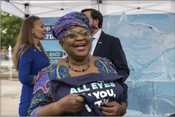  ?? KEYSTONE VIA AP ?? Nigeria’s Ngozi Okonjo-iweala, Director General of the World Trade Organizati­on, attends an event Wednesday on World Ocean Day with Finley the fish, made of ice, on place des Nations before of the World Trade Organizati­on Ministeria­l Conference where a deal to end harmful fisheries subsidies could be reached in Geneva, Switzerlan­d.