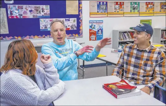  ?? L.E. Baskow Las Vegas Review-Journal @Left_Eye_Images ?? Mitchell Kalin, center, a seventh-grade history teacher at Justice Myron E. Leavitt Middle School in Las Vegas, talks with former students Tiara Simpson and Dante Carroll about teaching and learning about the Holocaust.