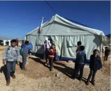  ?? JOSEPH EID/AFP/GETTY IMAGES ?? Syrian refugee children leave a tent being used as a school earlier this month at a refugee camp in Lebanon’s Bekaa Valley.