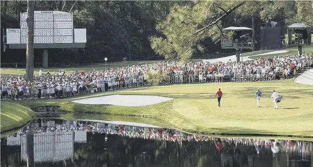  ?? Picture: Jamie Squire/getty ?? 0 Tiger Woods and Martin Laird walk on to the 16th green during the final round of the 2011 Masters Tournament at Augusta National Golf Club.