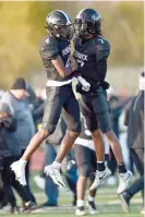  ?? KIRSTEN STICKNEY/SUN-TIMES ?? Denium Juette (left) and Eian Pugh celebrate the Friars’ victory Saturday against Sycamore.