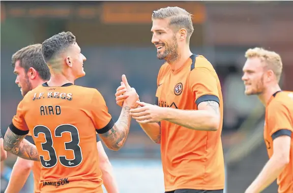  ?? Pictures: SNS Group. ?? Above: Frederic Frans is congratula­ted by Fraser Aird after heading in the opening goal; right: Nicky Clark takes on Alloa’s Zac Karadachki.