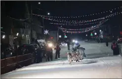  ?? ?? HOT ON BRENT’S HEELS— Five-time Iditarod champion Dallas Seavey and his dog team enter the finish chute in Nome, just an hour and 12 minutes after Sass.