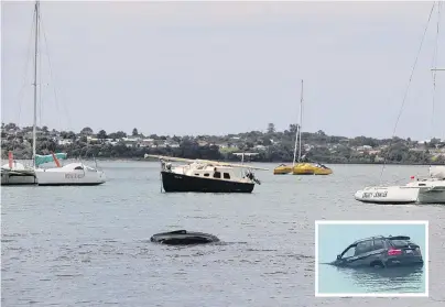  ?? PHOTO: NZME ?? Going down . . . A BMW SUV slowly sinks into Auckland Harbour yesterday.